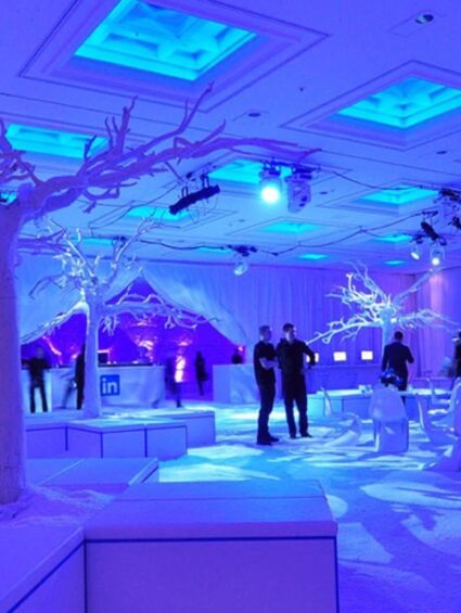 Artificial white branch tree for hire, in a white snow-style room with LinkedIn bars and blue ceiling lights