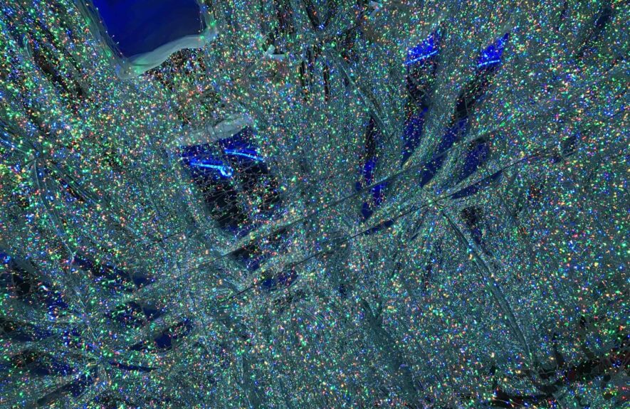 Close-up of sparkling green and blue glitter lights seen from underneath