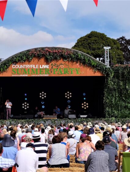 Artificial ivy walls and arch for hire, framing the 'Countryfile Live Summer Party' stage with a crowd in hats