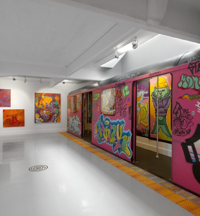 Pink graffiti train carriage with open doors on a recreated subway platform, D'Stassi Art Gallery, London