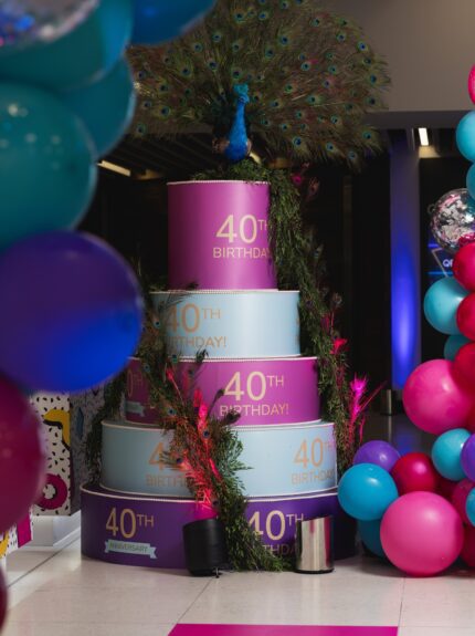Artificial peacock and trailing foliage for hire, on a tiered 40th Birthday cake display at the QEII Centre